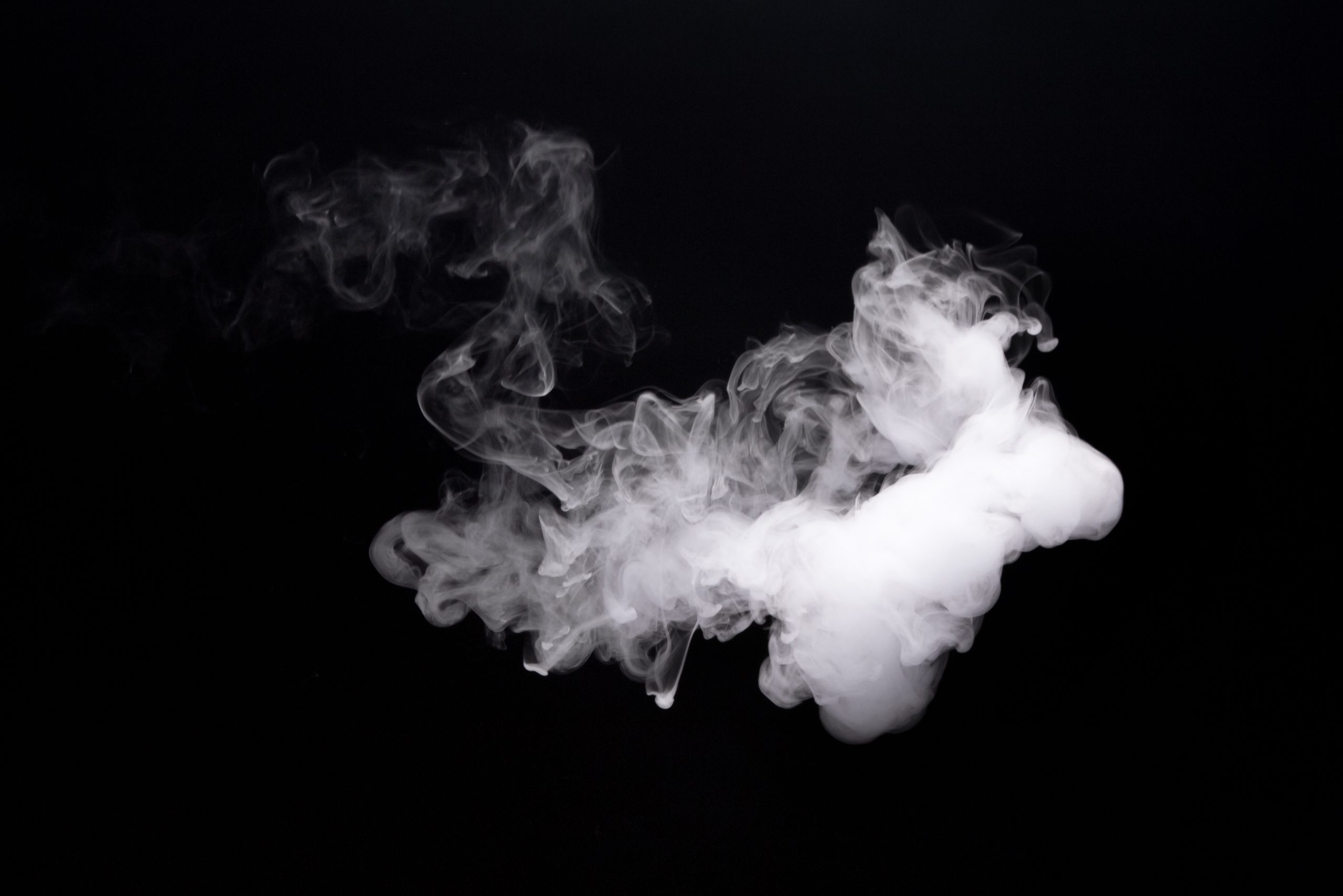 Cloud smoke of e-cigarette on black background